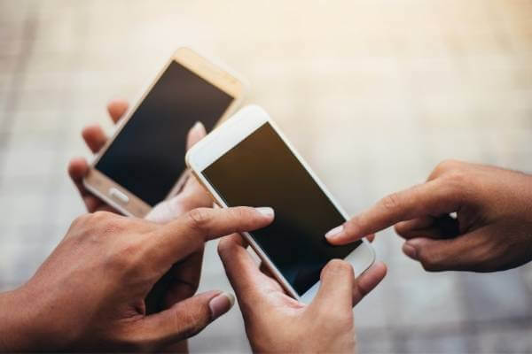 Two people connecting via phones. 